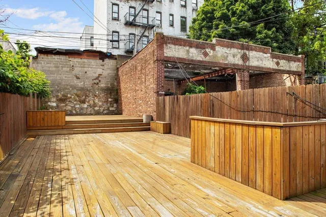 a view of a white building on the side of a street