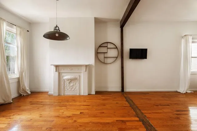 a view of empty room with a ceiling fan and a window