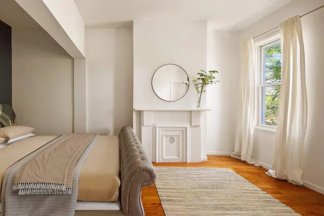 a bedroom with a bed and a fireplace