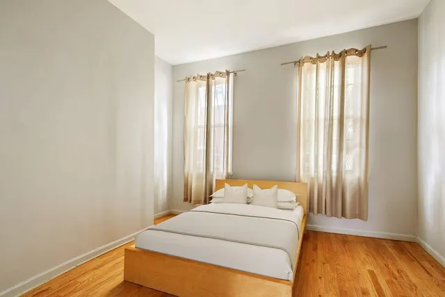 a bedroom with a bed and a window