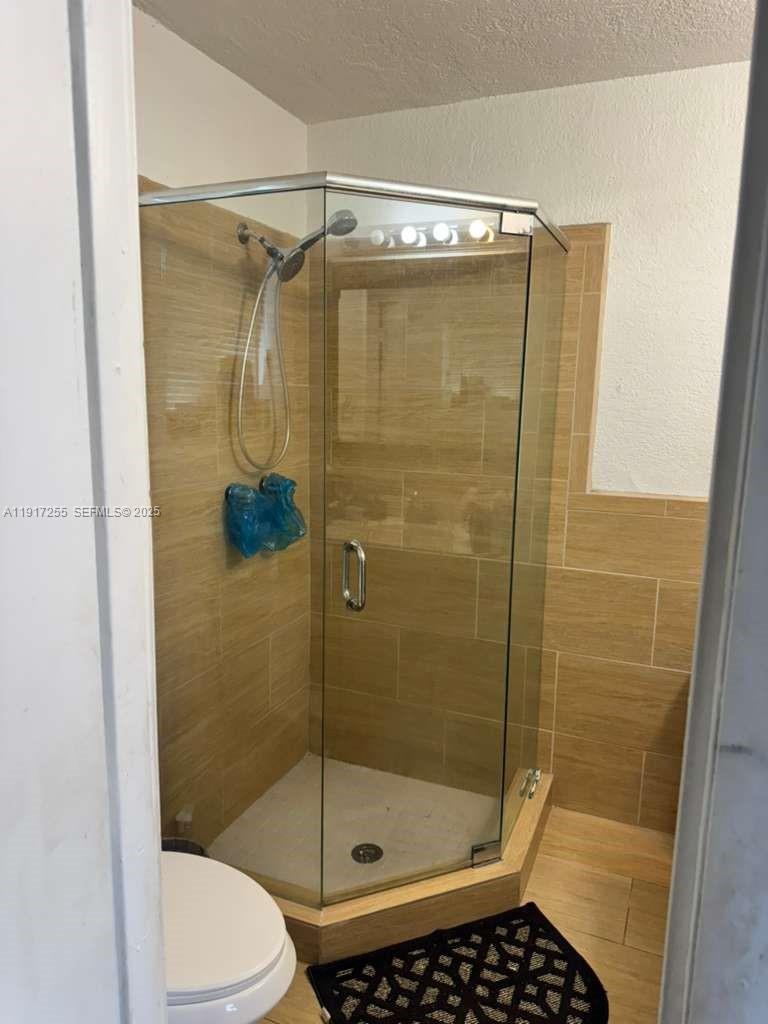 820 Southwest 49th Terrace Margate, FL 33068 - Photo 11 of 15 a bathroom with a shower and a toilet