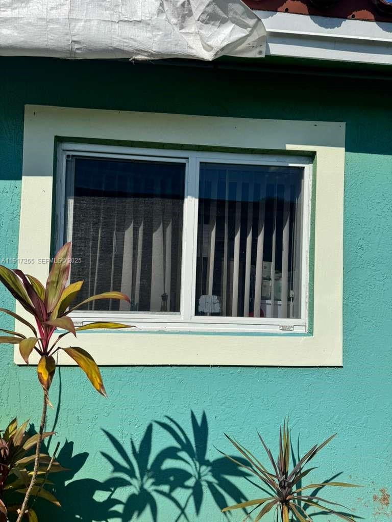 820 Southwest 49th Terrace Margate, FL 33068 - Photo 15 of 15 a view of a house with a window and wooden fence