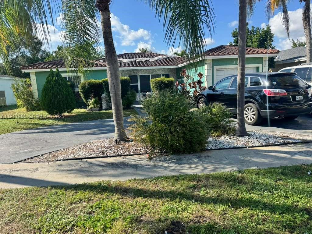 820 Southwest 49th Terrace Margate, FL 33068 - Photo 2 of 15 a front view of a house with garden