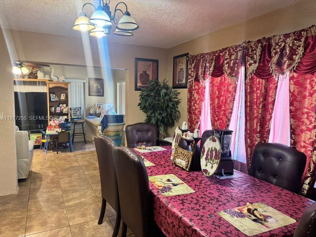 820 Southwest 49th Terrace Margate, FL 33068 - Photo 7 of 15 a view of a dining room with furniture and chandelier