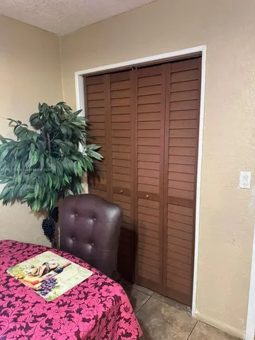 a bedroom with a bed and a potted plant