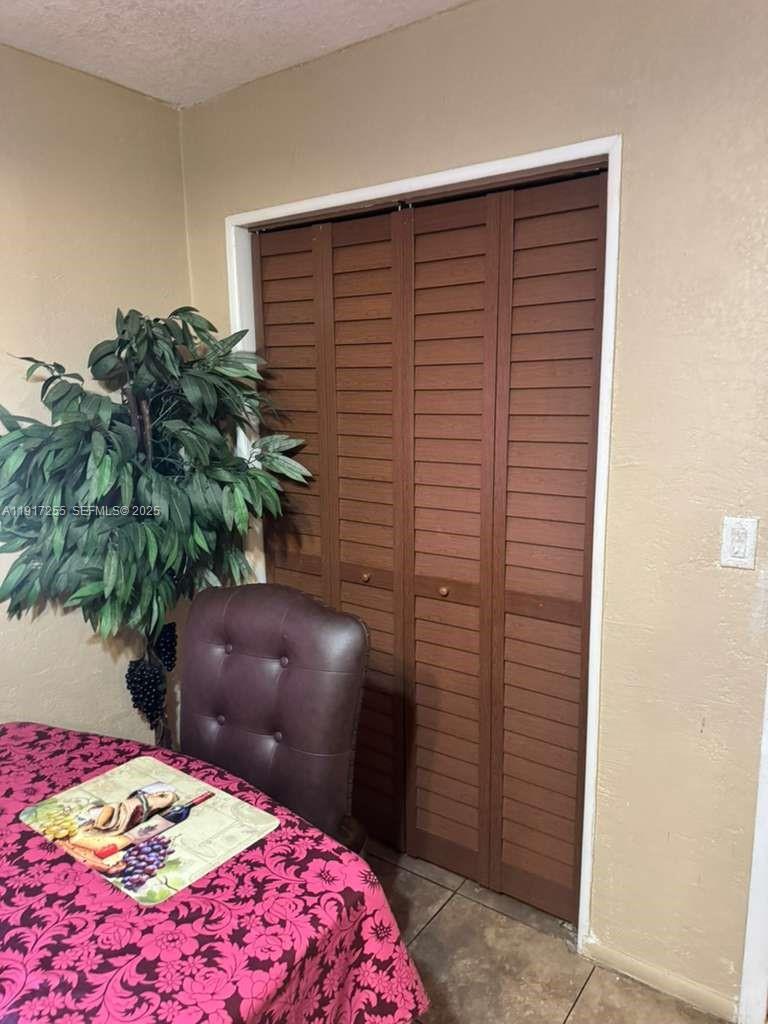 820 Southwest 49th Terrace Margate, FL 33068 - Photo 8 of 15 a bedroom with a bed and a potted plant