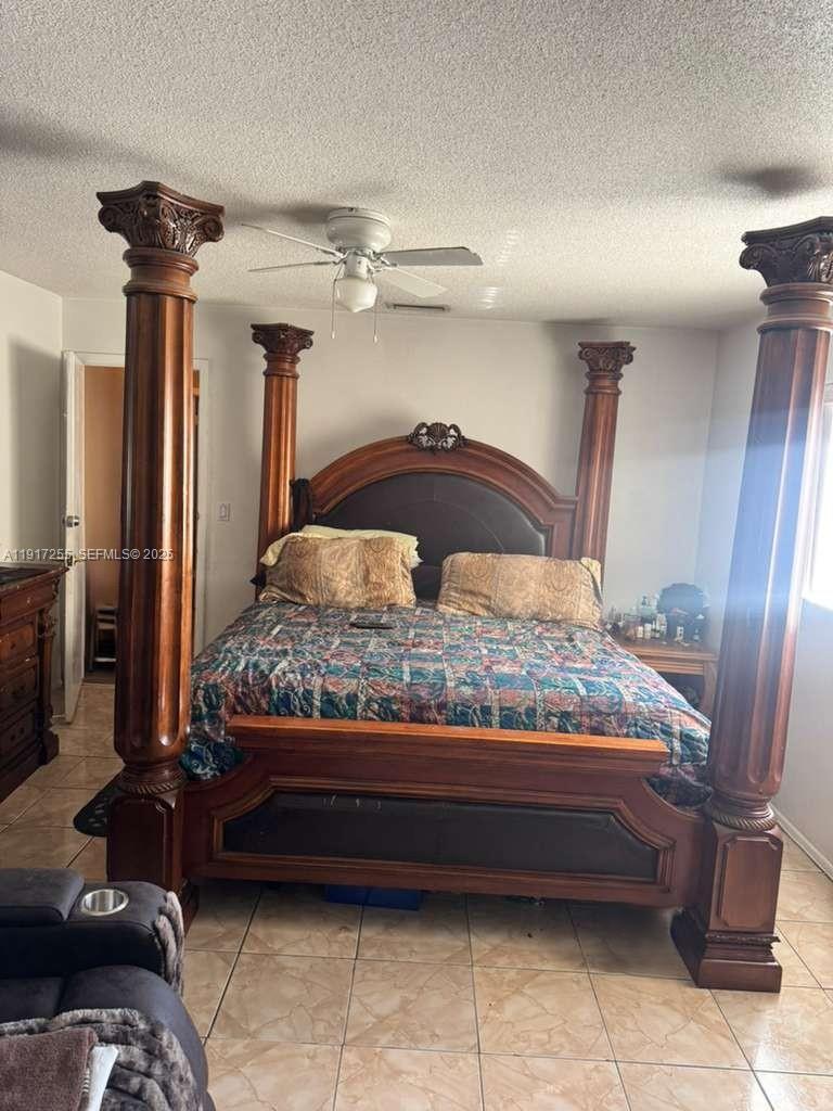 820 Southwest 49th Terrace Margate, FL 33068 - Photo 9 of 15 a bedroom with a bed and a mirror