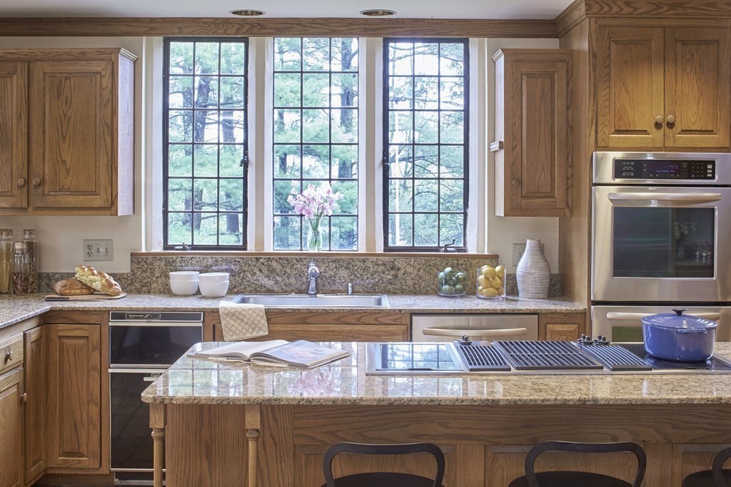 89 Fletcher Road Belmont, MA 02478 - Photo 12 of 32 a kitchen with granite countertop a stove a sink and a counter space