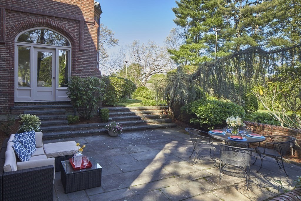 89 Fletcher Road Belmont, MA 02478 - Photo 21 of 32 a view of a patio with couches table and chairs and potted plants