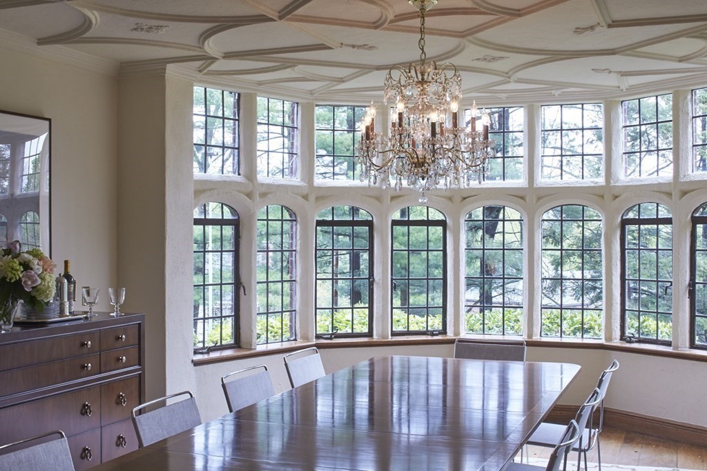89 Fletcher Road Belmont, MA 02478 - Photo 5 of 32 a view of a dining room with furniture large windows and a chandelier