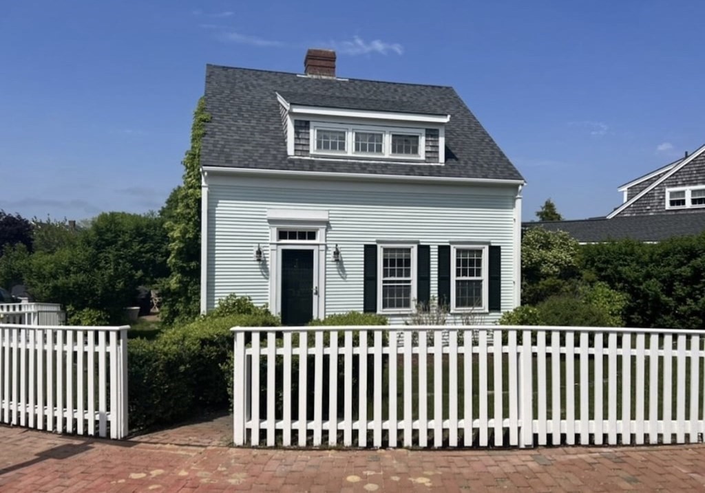 23 Kittiwake Lane Nantucket, MA 02554 - Photo 1 of 36 a front view of a house with a garden