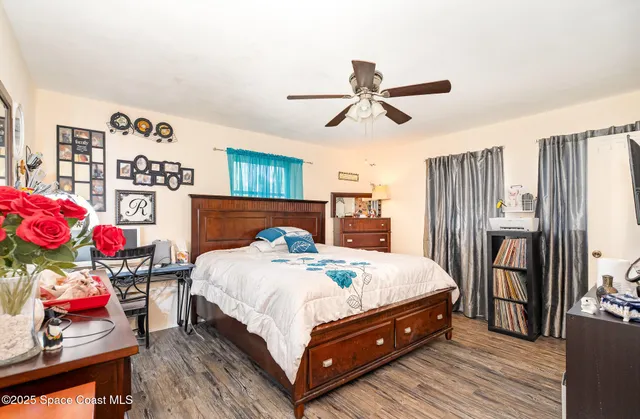 a bedroom with bed and wooden floor