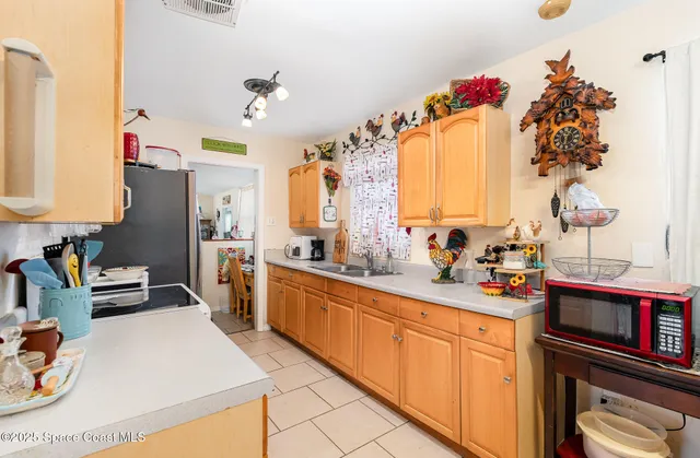 a kitchen with stainless steel appliances a sink stove and cabinets