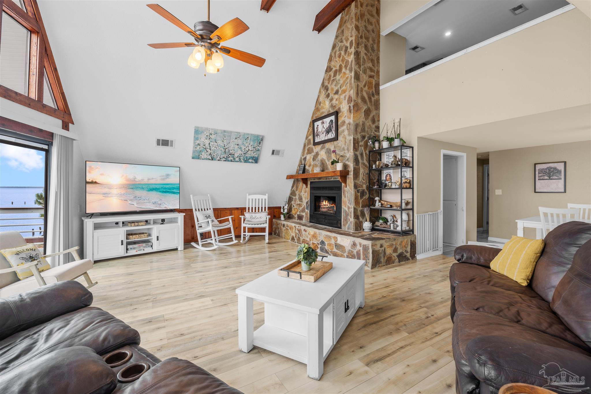 889 Dolphin Road Milton, FL 32583 - Photo 11 of 67 a living room with furniture and a flat screen tv
