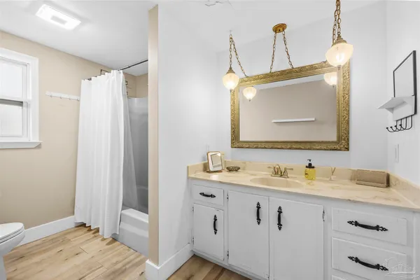 a spacious bathroom with a double vanity sink and a mirror