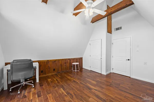 a bathroom with a toilet and a shower curtain