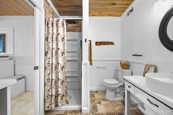 a bathroom with a sink a toilet and a mirror