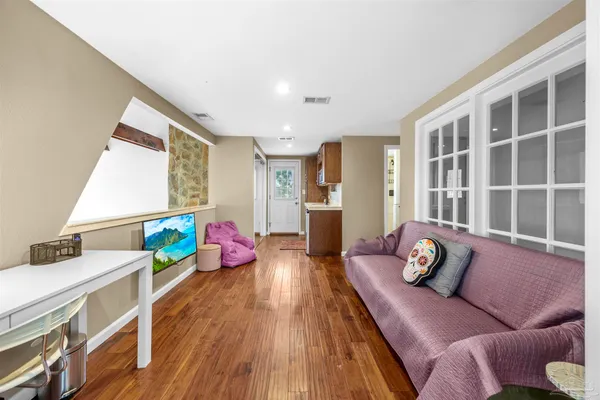 a living room with furniture a flat screen tv and a fireplace