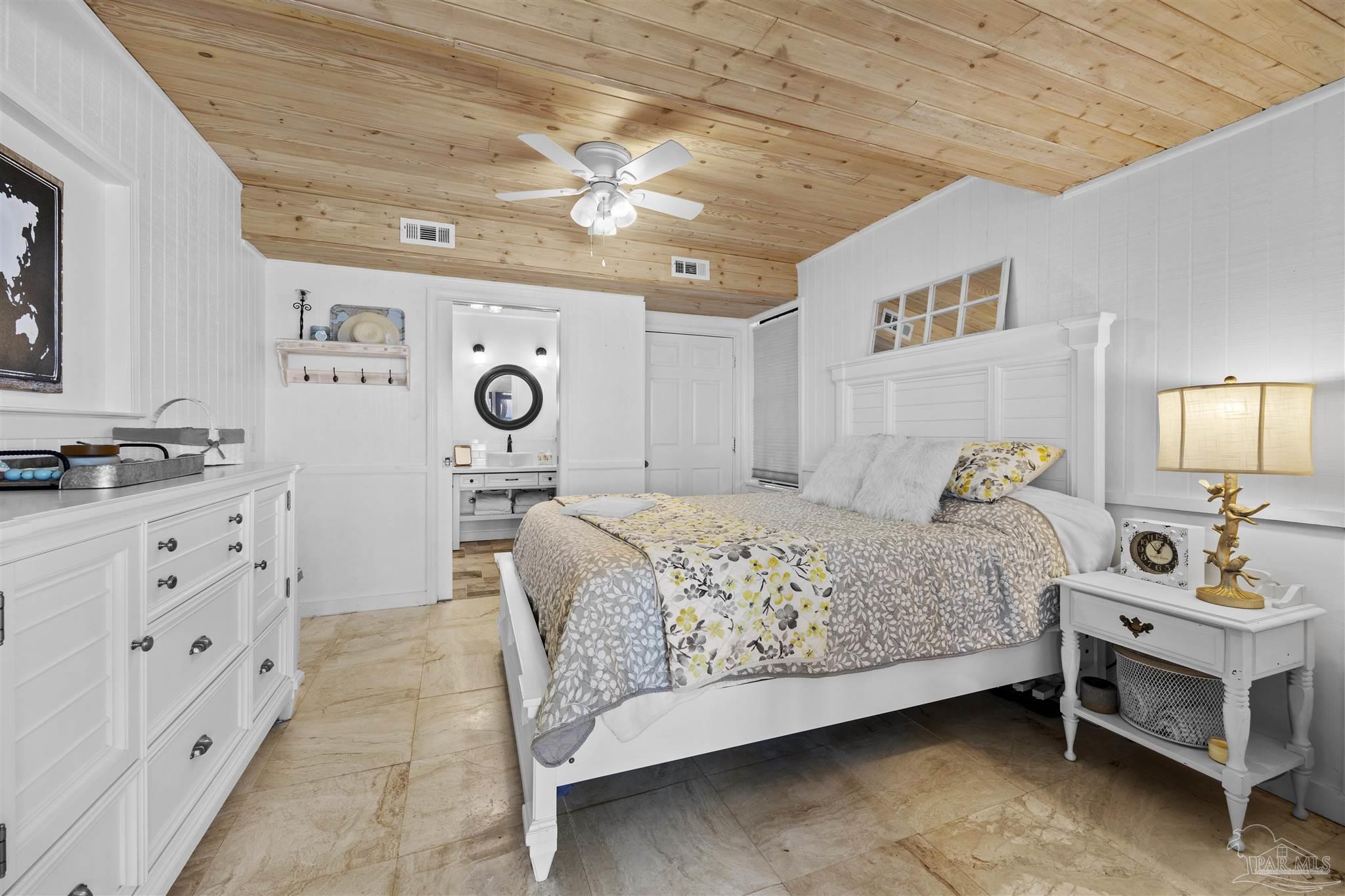 889 Dolphin Road Milton, FL 32583 - Photo 27 of 67 a bedroom with a bed and dresser