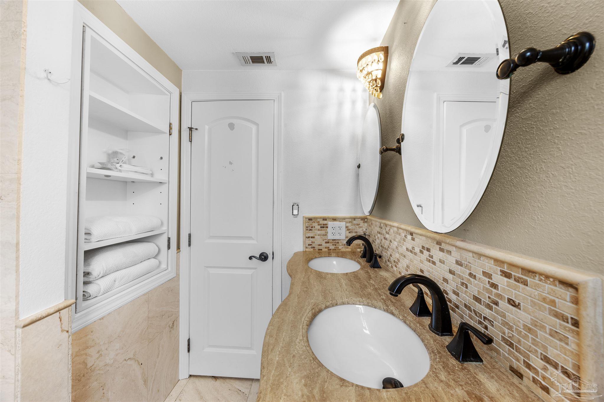 889 Dolphin Road Milton, FL 32583 - Photo 35 of 67 a bathroom with a sink mirror vanity and shower