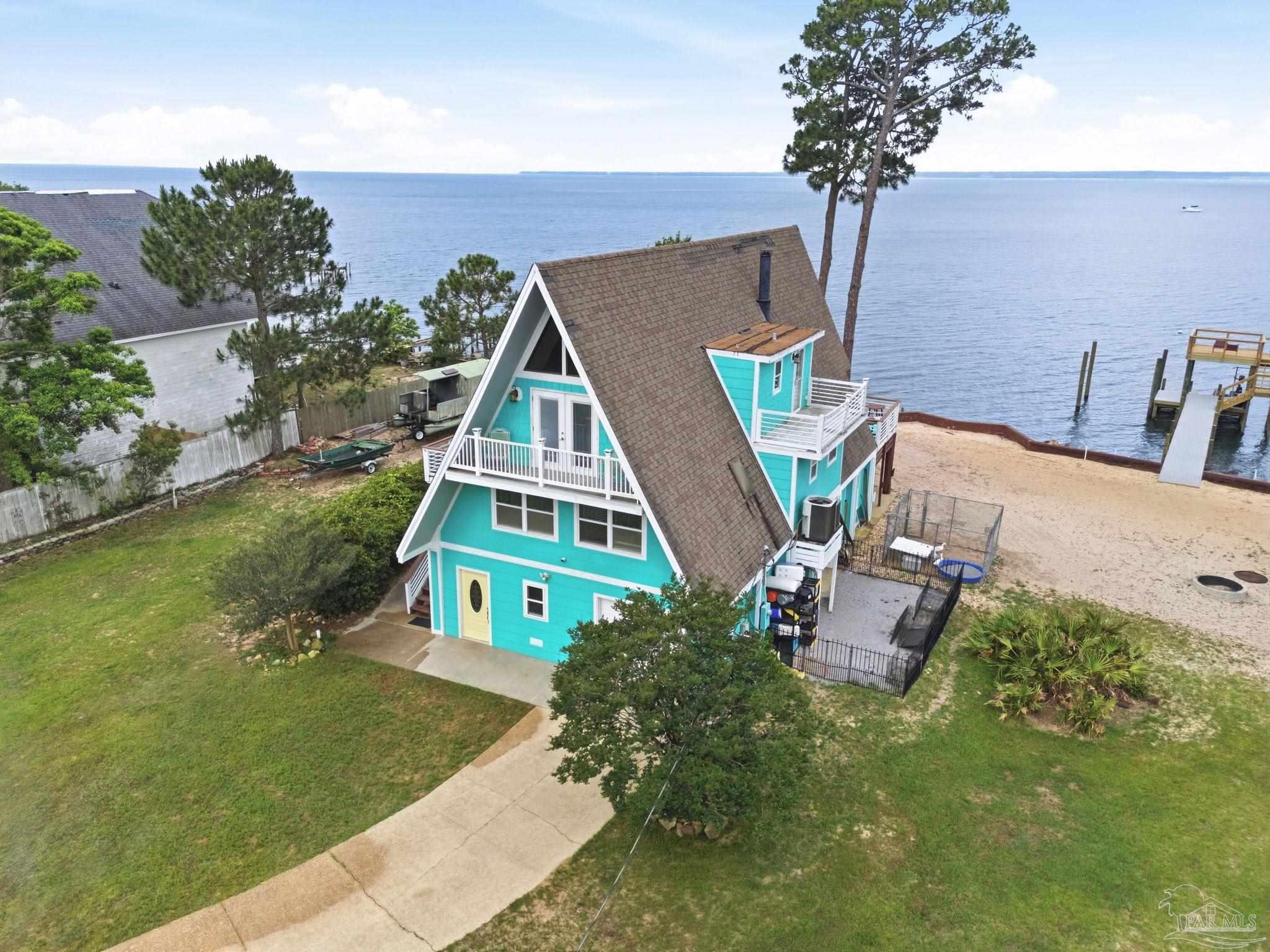 889 Dolphin Road Milton, FL 32583 - Photo 4 of 67 an aerial view of a house with outdoor space
