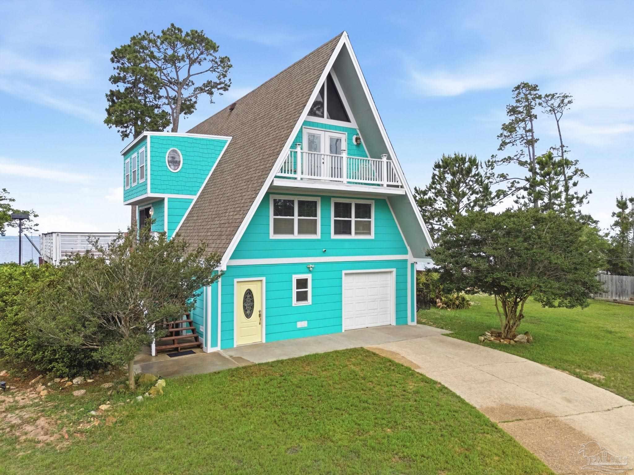 889 Dolphin Road Milton, FL 32583 - Photo 5 of 67 a front view of a house with a yard