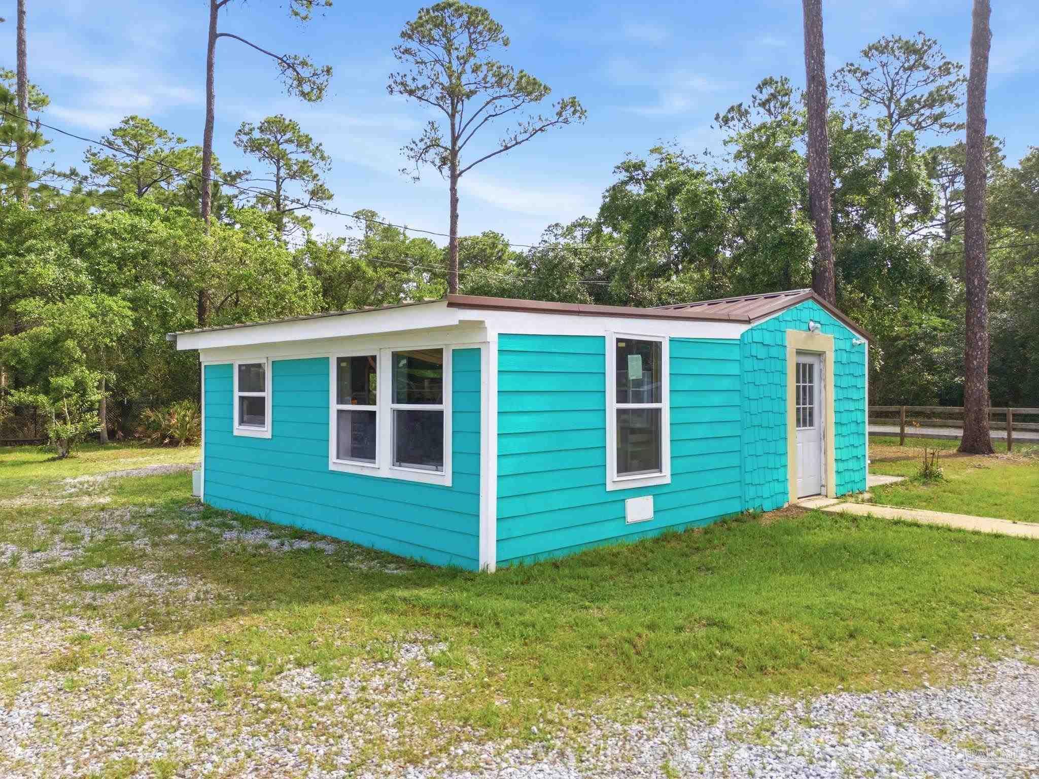 889 Dolphin Road Milton, FL 32583 - Photo 56 of 67 a view of a house with a backyard