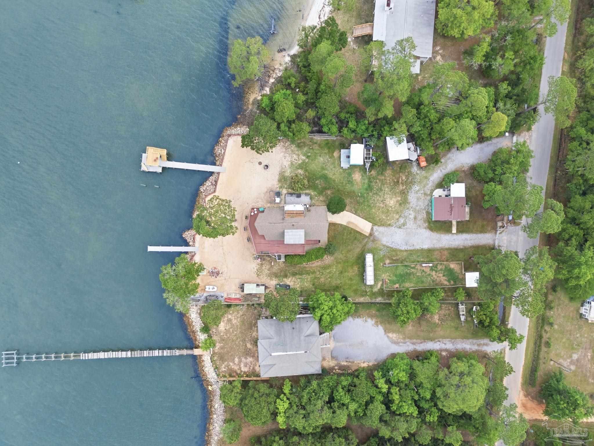 889 Dolphin Road Milton, FL 32583 - Photo 65 of 67 an aerial view of a house with a yard and lake view