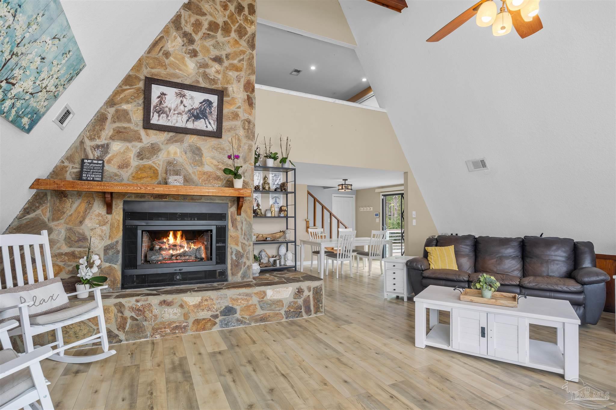 889 Dolphin Road Milton, FL 32583 - Photo 10 of 67 a living room with furniture and a fireplace