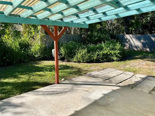 a view of a garden with wooden fence