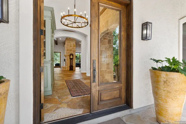 a view of a hallway with wooden floor and a dining room