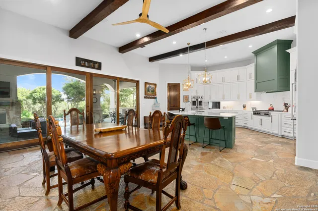 a dining room with furniture and a floor to ceiling window