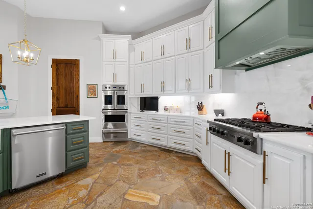 a kitchen with stainless steel appliances a stove and cabinets