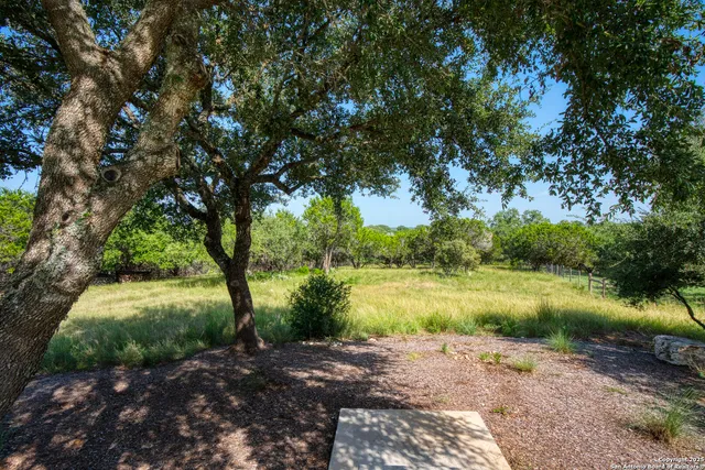 an aerial view of a house with yard and outdoor seating