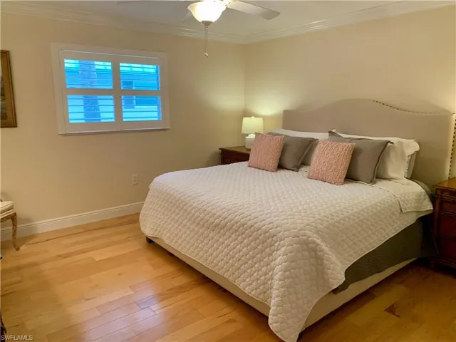 a large bed sitting in a bedroom next to a window