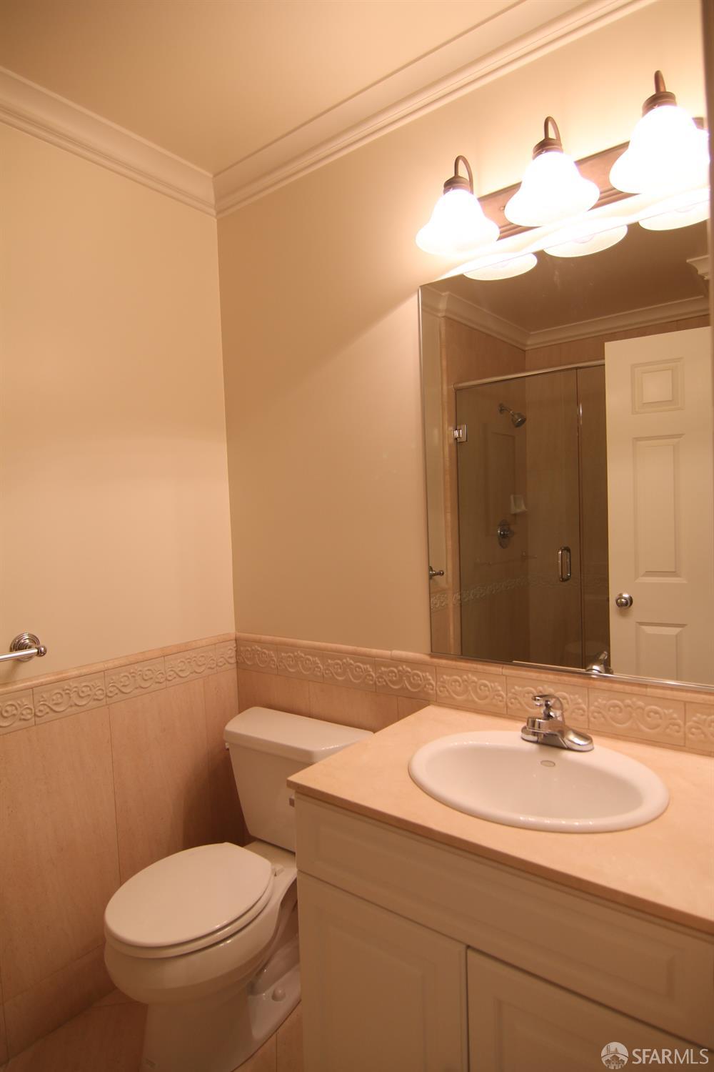 471 7th Avenue, Unit 2 San Francisco, CA 94118 - Photo 5 of 7 a bathroom with a sink and a mirror