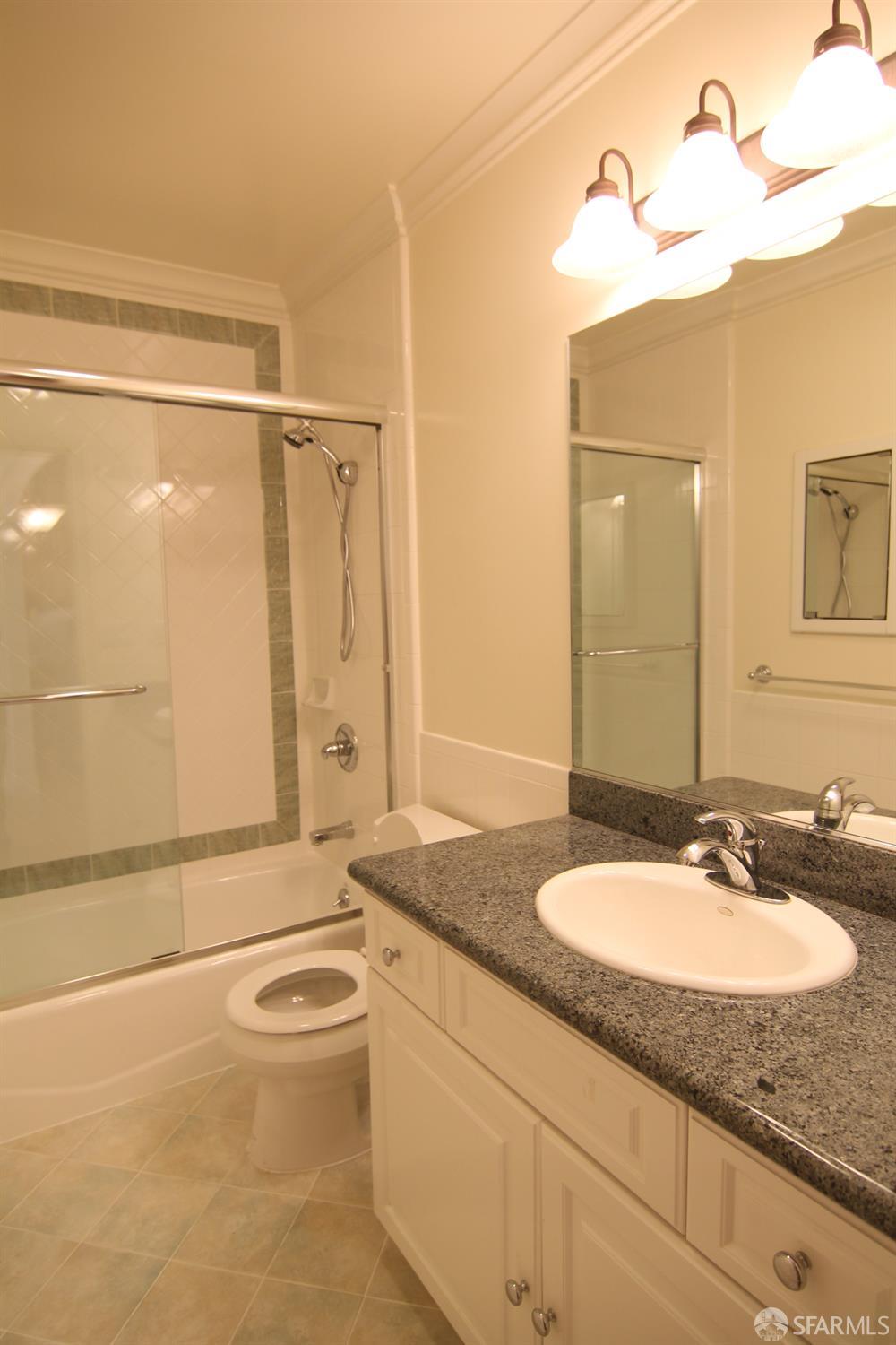 471 7th Avenue, Unit 2 San Francisco, CA 94118 - Photo 7 of 7 a bathroom with a granite countertop sink a mirror and a bathtub
