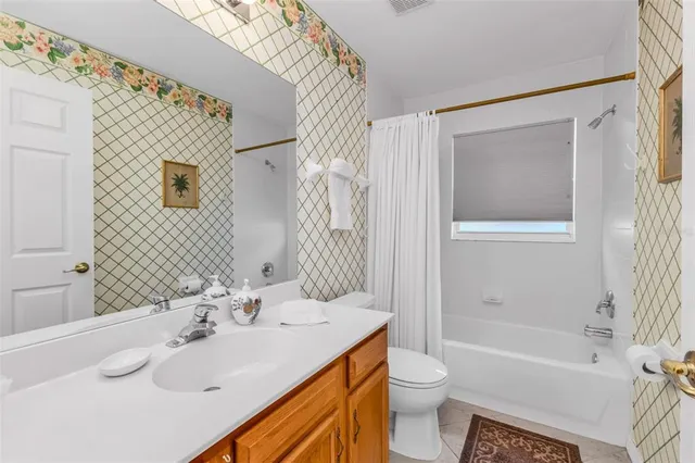 a bedroom with a bed a mirror and a chandelier