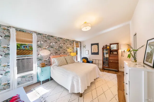 a bedroom with a large bed and a large window