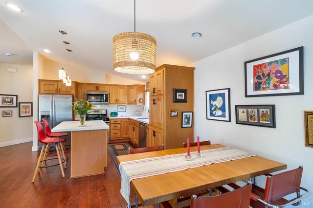 a view of a dining room with furniture a chandelier and wooden floor