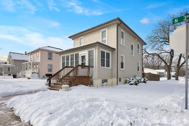 a view of a house with a snow in the yard