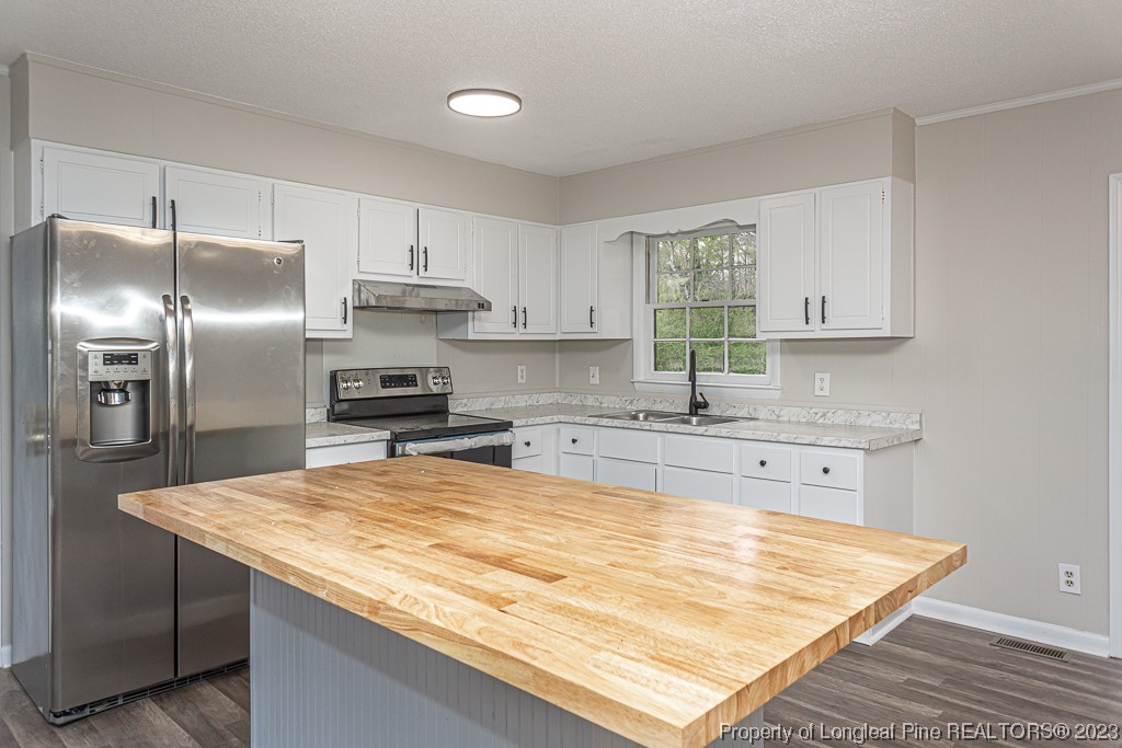 2179 Shaw Rd Extension Fayetteville, NC 28311 - Photo 11 of 42 a kitchen with granite countertop a sink stainless steel appliances and white cabinets