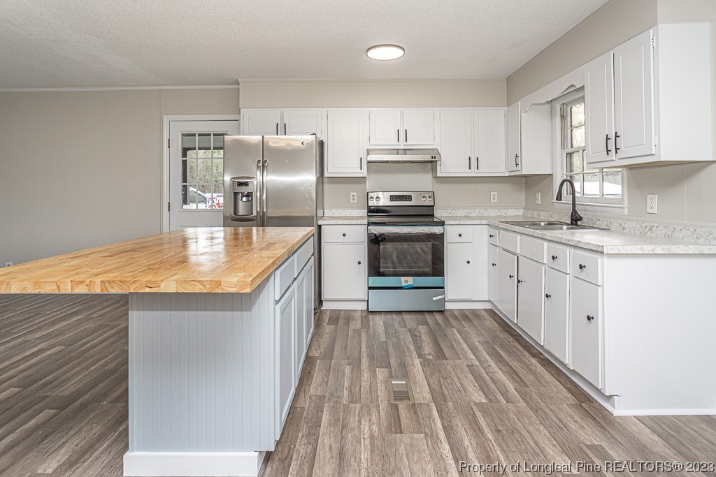2179 Shaw Rd Extension Fayetteville, NC 28311 - Photo 12 of 42 a kitchen with stainless steel appliances granite countertop a sink stove refrigerator and cabinets