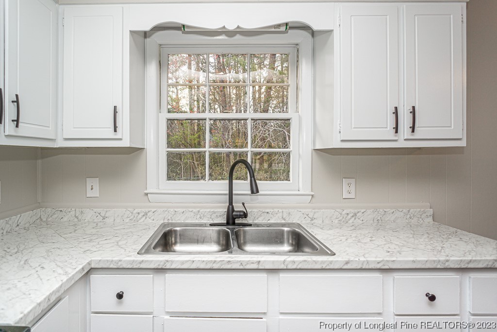 2179 Shaw Rd Extension Fayetteville, NC 28311 - Photo 13 of 42 a kitchen with appliances cabinets a sink and a window