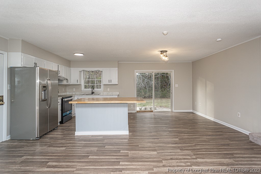 2179 Shaw Rd Extension Fayetteville, NC 28311 - Photo 16 of 42 a kitchen with stainless steel appliances granite countertop a refrigerator sink and cabinets