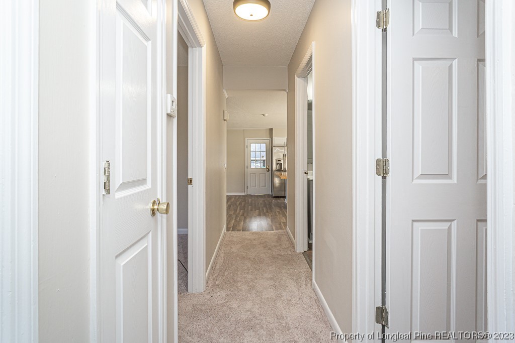 2179 Shaw Rd Extension Fayetteville, NC 28311 - Photo 17 of 42 a view of a hallway with wooden floor and closet area