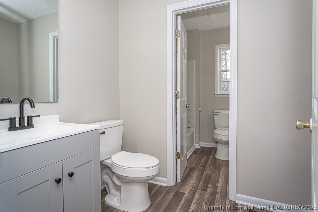 2179 Shaw Rd Extension Fayetteville, NC 28311 - Photo 27 of 42 a bathroom with a toilet a sink and mirror