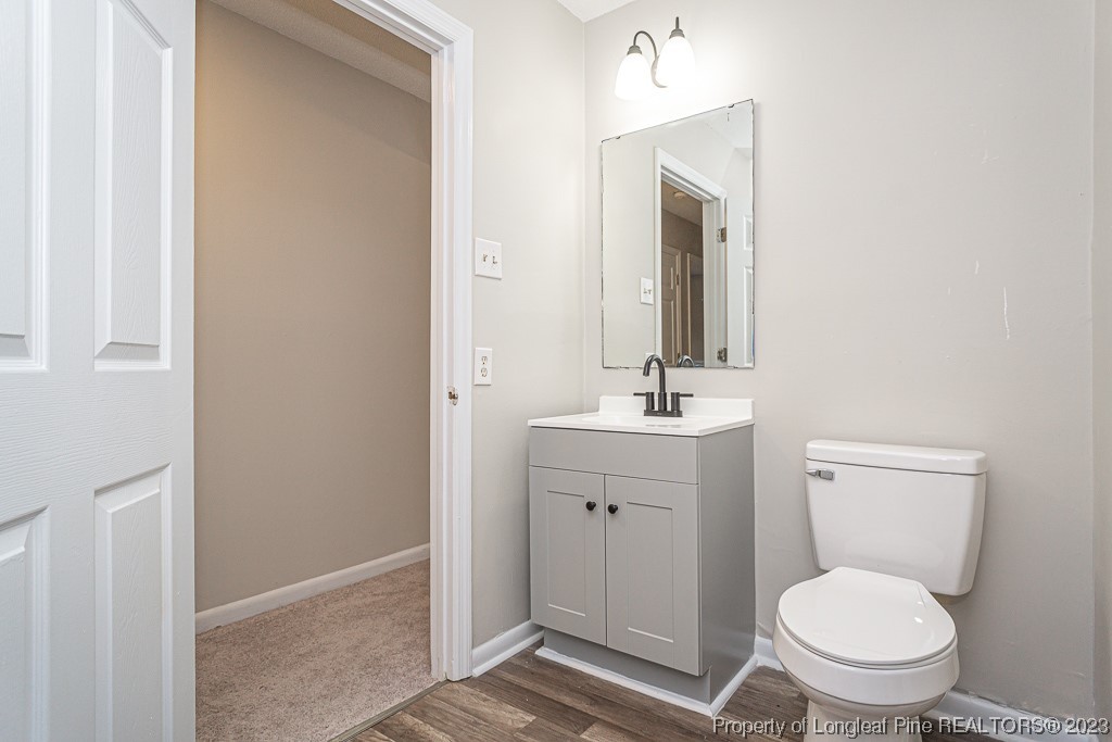 2179 Shaw Rd Extension Fayetteville, NC 28311 - Photo 28 of 42 a bathroom with a toilet a sink and mirror