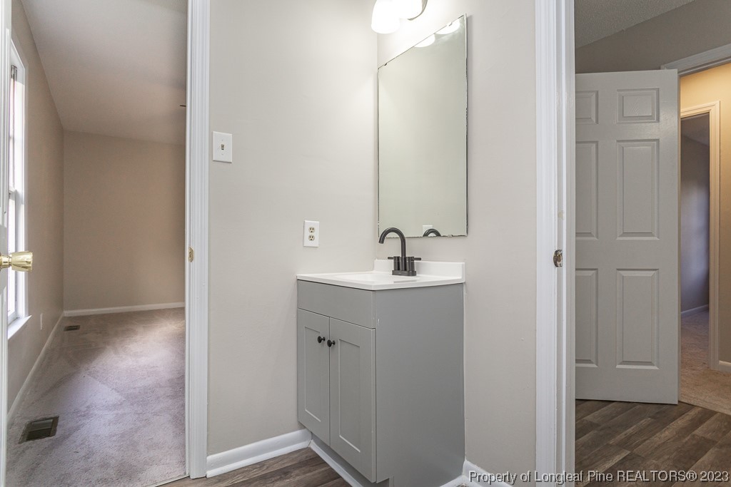 2179 Shaw Rd Extension Fayetteville, NC 28311 - Photo 30 of 42 a bathroom with a sink and mirror