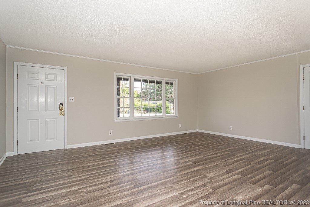 2179 Shaw Rd Extension Fayetteville, NC 28311 - Photo 7 of 42 an empty room with wooden floor and windows